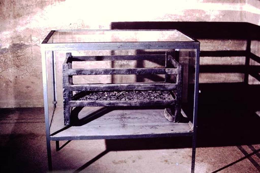 Ins. Orientalis I, 1a, Herculaneum, 1975. Photo by Stanley A. Jashemski.
Source: The Wilhelmina and Stanley A. Jashemski archive in the University of Maryland Library, Special Collections (See collection page) and made available under the Creative Commons Attribution-Non Commercial License v.4. See Licence and use details. J75f0699
According to “Guida”- a cradle in carbonized wood was found in the House of M. Pilius Primigenius Granianus.
See Guidobaldi, M.P (2009). Ercolano, guida aglia Scavi. Electa, Napoli, (p.8)